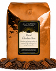 5 lb coffee bag labeled 'Decaf Chocolate Pecan' with chocolate pecan flavor, surrounded by coffee beans, chocolate, and pecans on a white background.