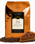 5 lb J.L. Hufford Decaf Pecanilla coffee bag with coffee beans and a slice of buttery pecan pie on a white background