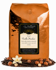 5 lb J.L. Hufford Decaf Vanilla Hazelnut coffee bag with coffee beans, vanilla sticks, and hazelnuts on a white background