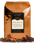 5 lb J.L. Hufford Antigua Guatemalan coffee bag with coffee beans, chocolate shavings and cinnamon sticks in front of the coffee bag