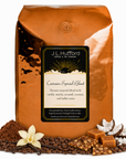 5 lb J.L. Hufford Castanza Special Blend coffee bag with coffee beans, powder mocha, vanilla sticks, shaved coconut, toffee bark, and blocks of caramel on a white background