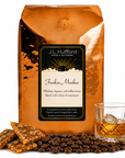 5 lb Funkee Monkee coffee beans bag with coffee beans, toffee bark, and a glass of whiskey in front displayed on a white background