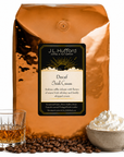 5 lb J.L. Hufford Decaf Irish Cream coffee bag with coffee beans, glass of Irish whiskey, and bowl of whipped cream on a white background
