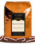 5 lb Peppermint Candy Cane coffee beans bag with coffee beans and peppermint candy canes in front displayed on a white background