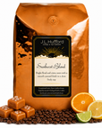 5 lb Sunburst Blend coffee beans bag with coffee beans, salted caramel blocks, and citrus items in front displayed on a white background