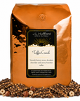 5 lb J.L. Hufford Toffee Crunch coffee bag with coffee beans, hazelnuts, and toffee bark with drizzled chocolate on a white background