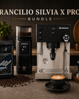 Rancilio Silvia X Pro coffee machine with Superautomatika coffee beans, grinder, tamper, and a cup of coffee on a wooden surface.