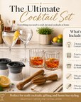 Cocktail set with glasses, ice molds, and tools on a kitchen counter.