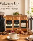 Coffee press package with coffee grinder, coffee bags, and a cup of coffee on a wooden table.