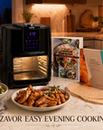 ZAVOR air fryer on a kitchen counter with cooked food, cookbook and air fryer liners.