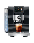 Front view of Diamond Black Jura espresso machine with an iced coffee in glass cup on stand displayed on a white background