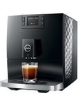 Black coffee machine with a glass of espresso on a white background