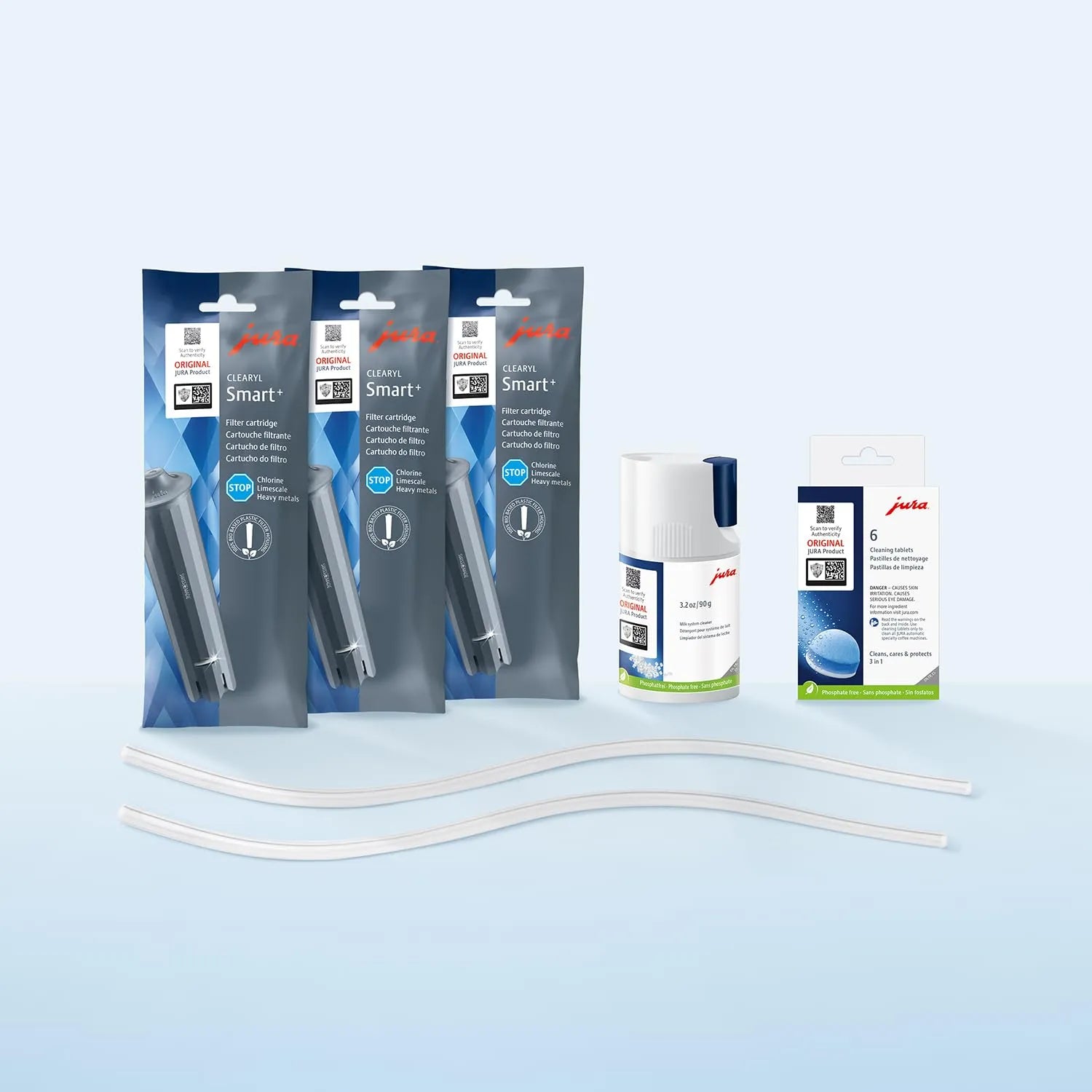 Jura coffee machine cleaning kit with three Smart+ filter pouches, a bottle to hold tablet cleaners, a box of tablet cleaners, and two clear replacement tubes on a light blue gradient background.