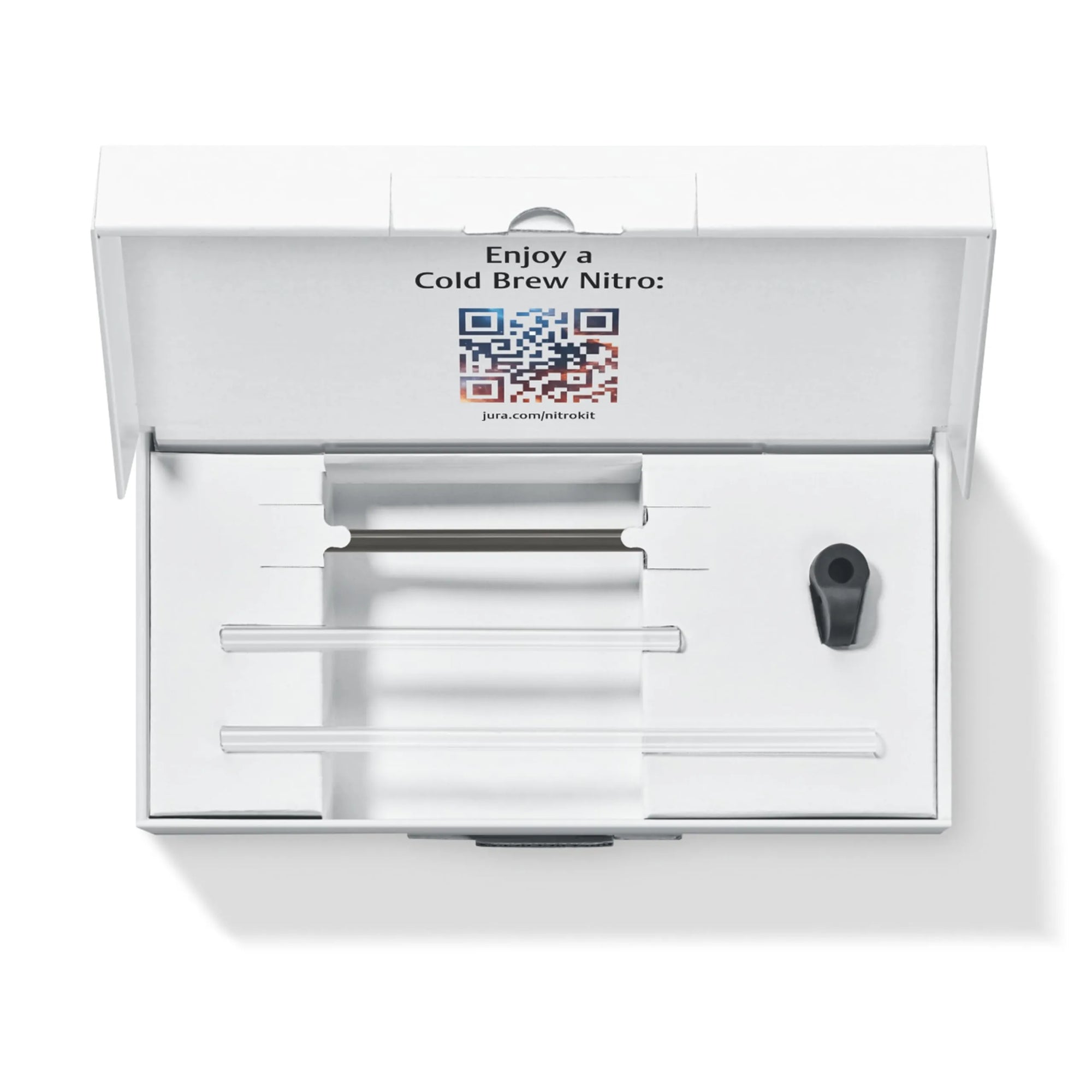 An open white presentation box containing cold brew equipment parts, including clear glass or acrylic rods and a small black component, with printed text and a QR code on the inside lid.