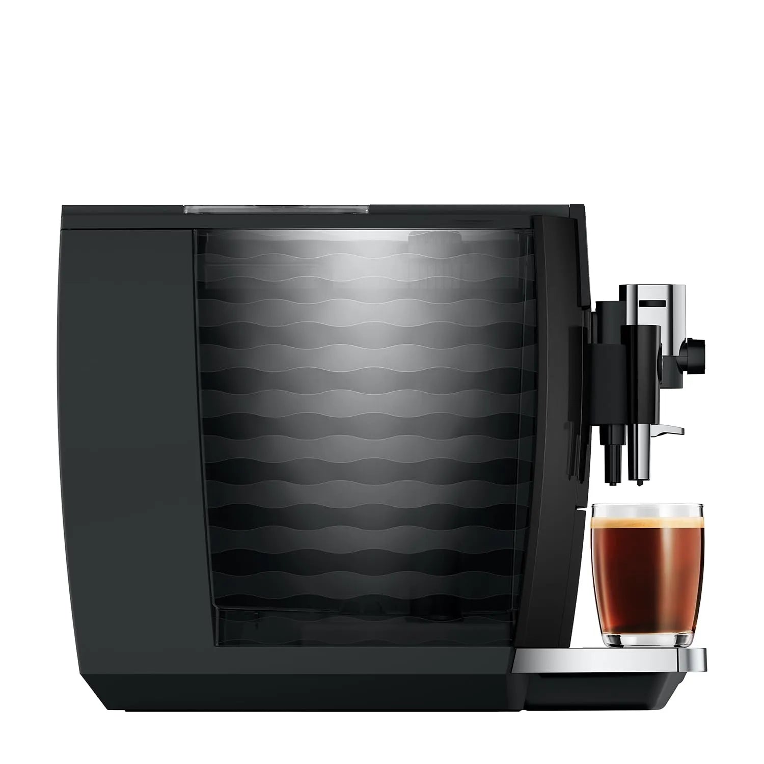 A sleek black coffee machine with a patterned glass water tank and a glass of espresso with foam on its drip tray, set against a solid white background.