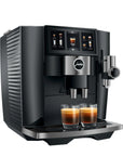 A black and silver Jura coffee machine with a digital touch screen, shown dispensing espresso into two glasses on a white background.