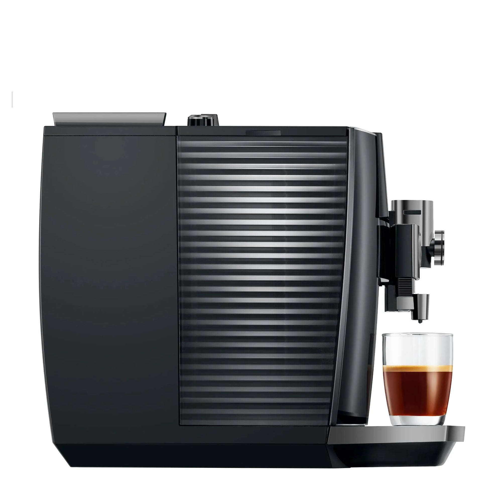 A sleek black coffee machine with a glass water tank and a glass of espresso on its drip tray, set against a solid white background.
