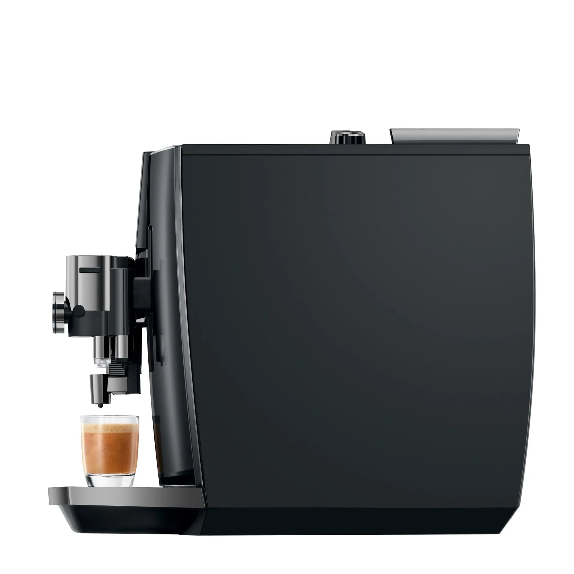A sleek black coffee machine with a small glass cup of espresso on its tray, shown against a solid white background.