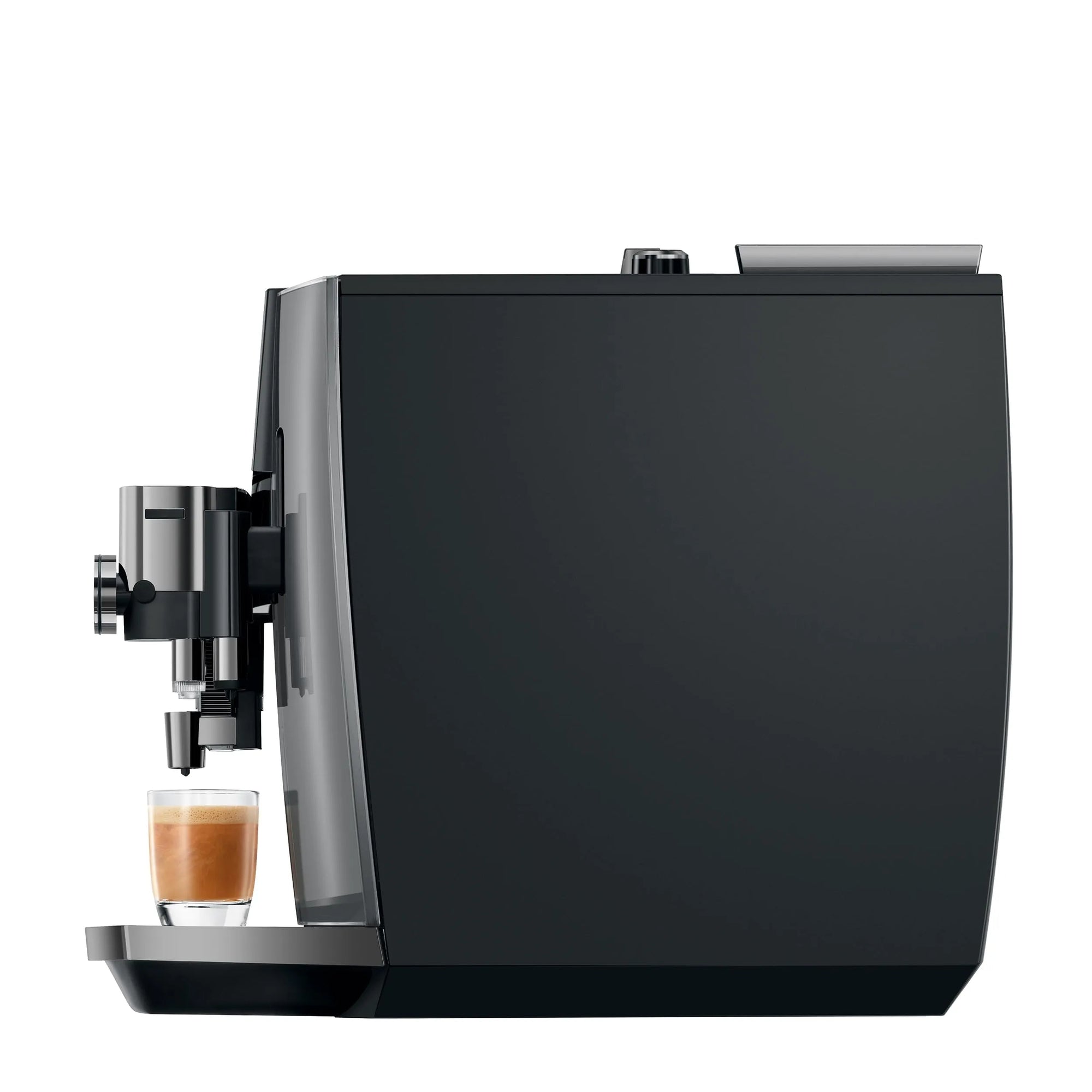 A sleek black coffee machine with a glass of espresso and milk on its drip tray, shown against a solid white background.