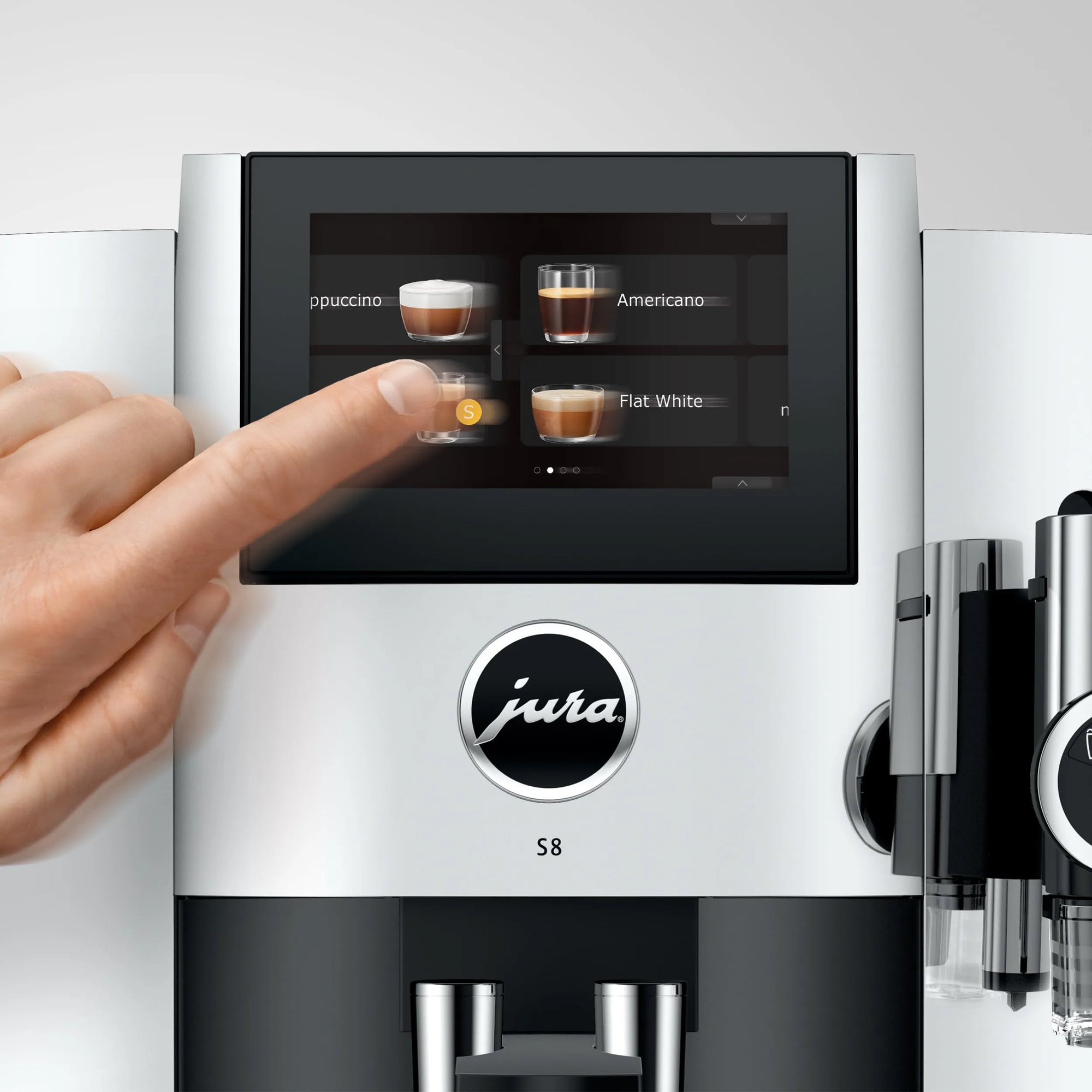 Jura coffee machine with a hand interacting with the touchscreen display.