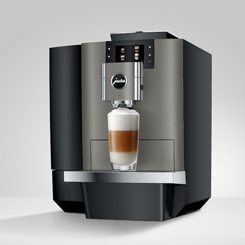 Modern coffee machine with a glass of layered coffee on a light gray background