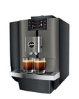 A modern Jura commercial-style coffee machine in dark gray and black, shown with two glasses of espresso on the front tray against a plain white background.