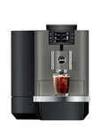 Modern coffee machine with a glass of iced coffee on a white background