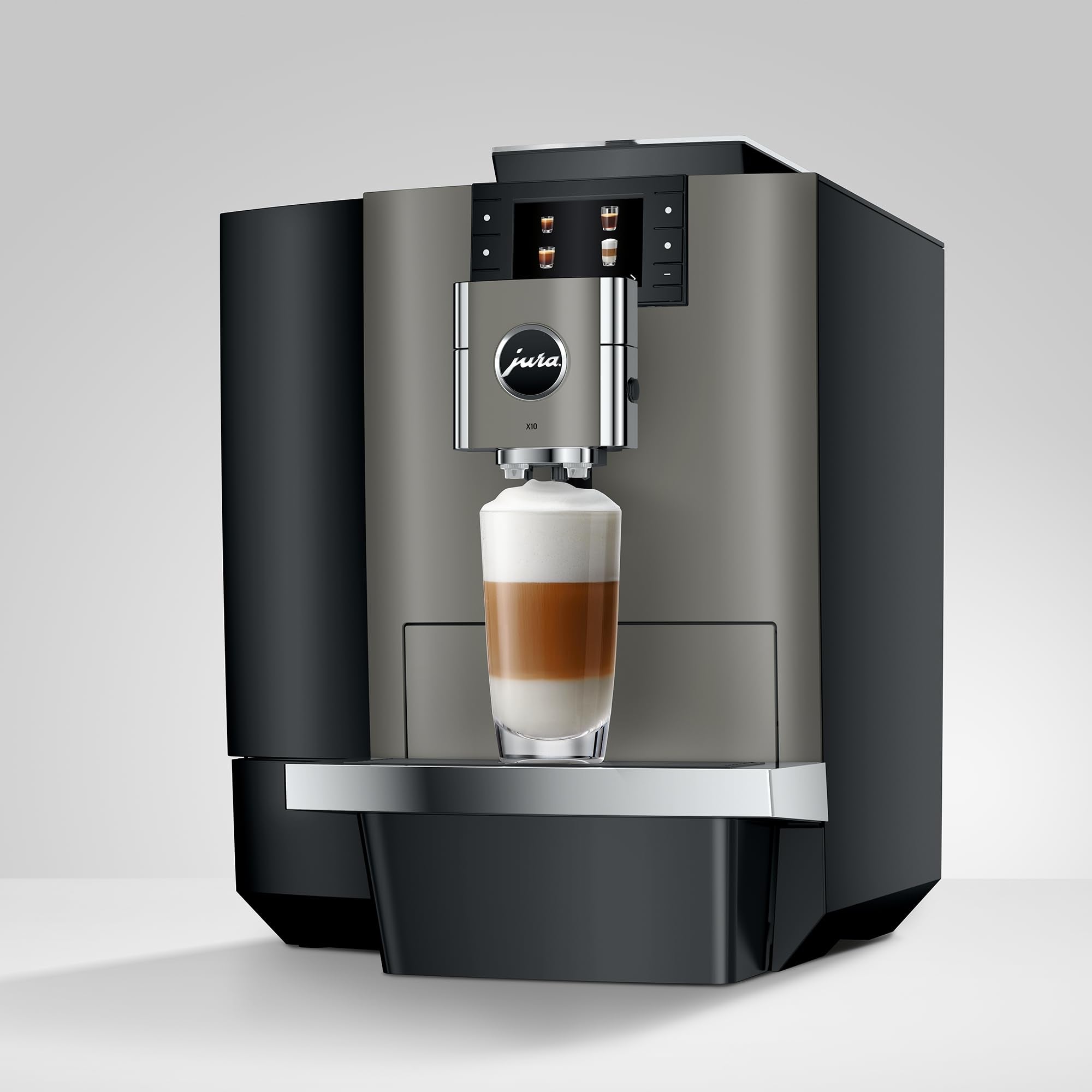 Jura X10 coffee machine with a glass of layered coffee on a light gray background