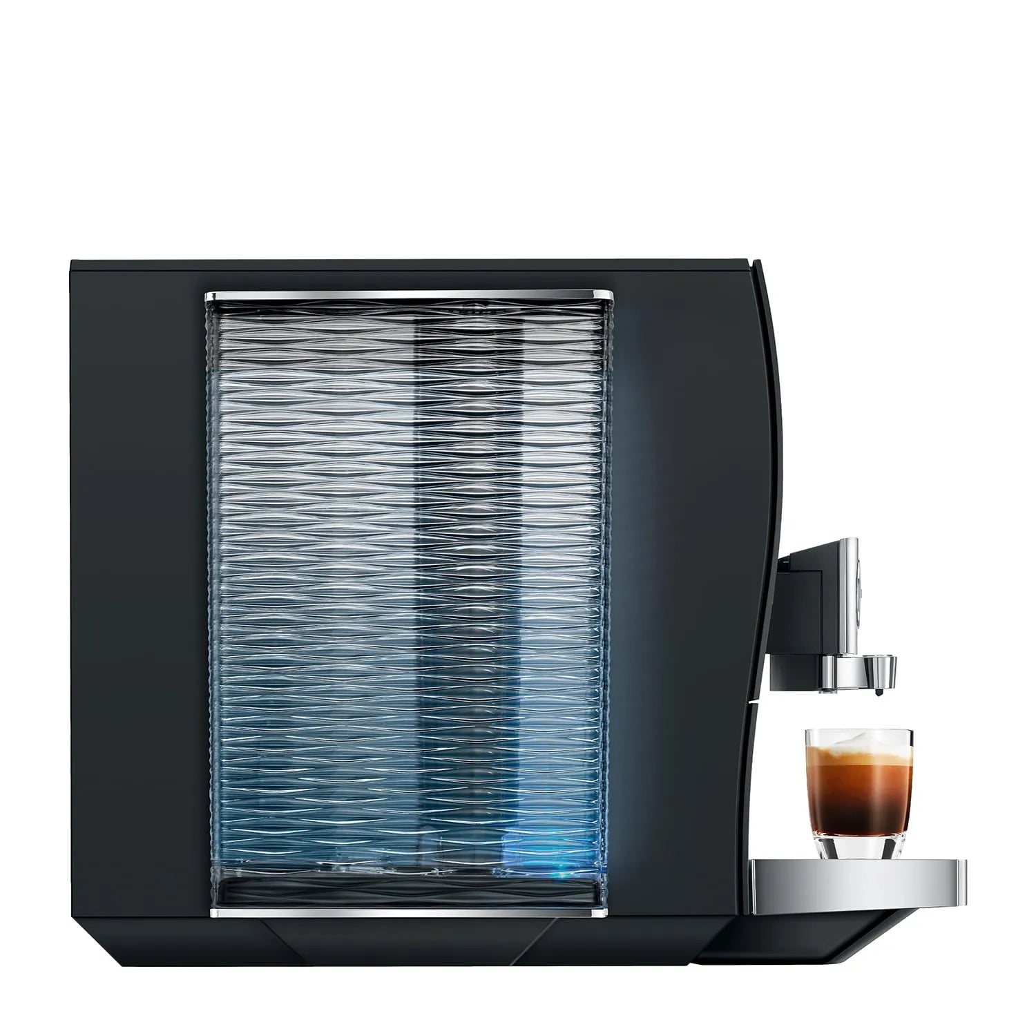 A sleek black coffee machine with a textured glass water tank and a small glass cup of espresso on a silver tray, shown against a solid white background.