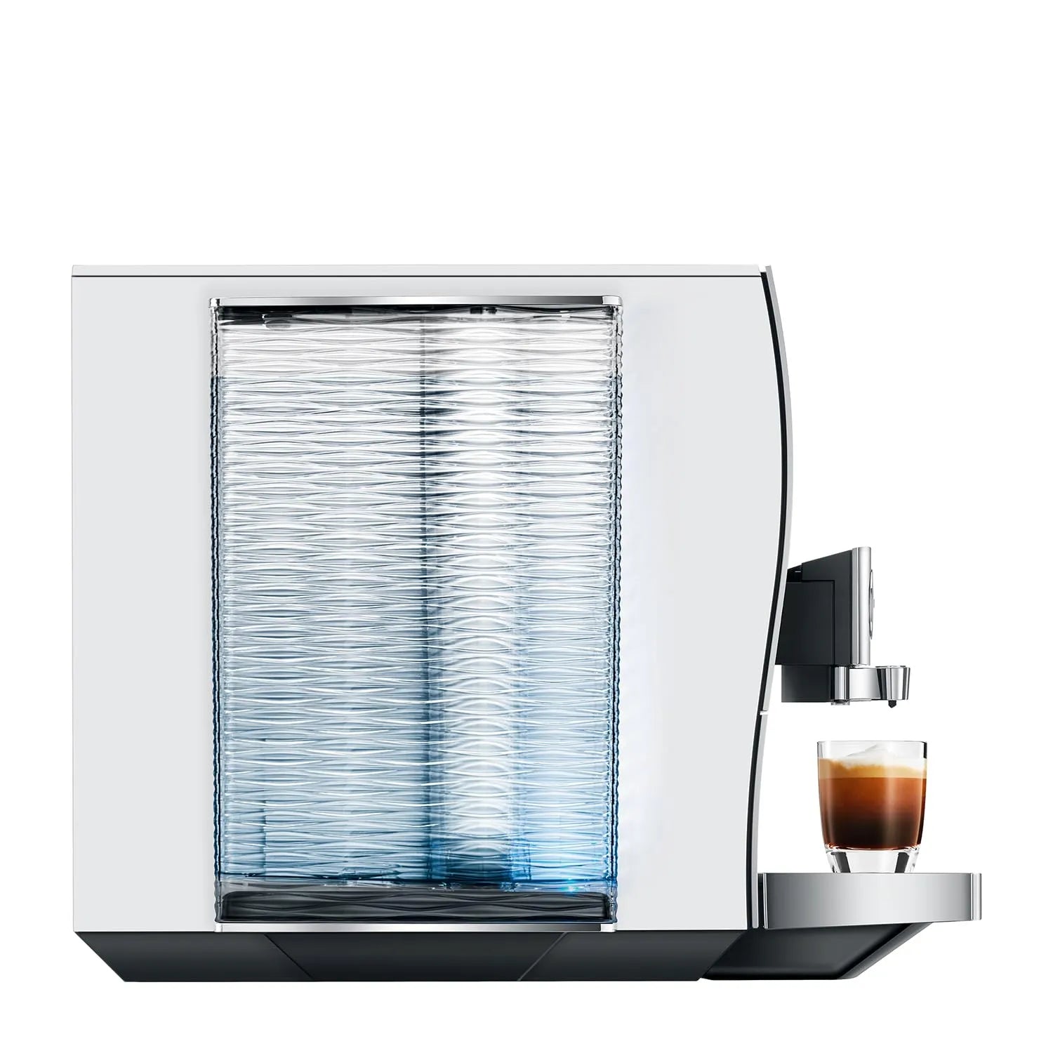 A modern white coffee machine with a textured clear water tank and a small glass of espresso on its drip tray, shown against a solid white background.
