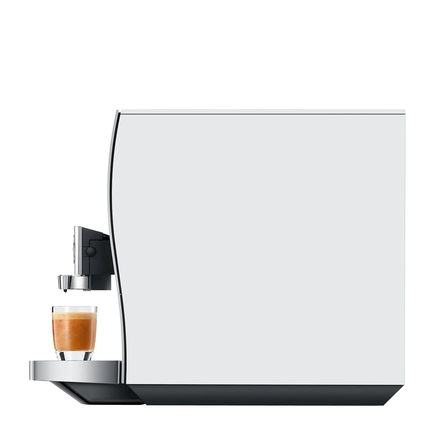 Side view of a modern white coffee machine with a glass of espresso and milk coffee on the drip tray, shown against a solid white background.