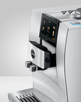 Side view of Diamond White Jura espresso machine with a touchscreen panel displayed on a white background