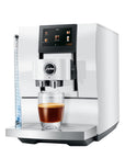 Diamond White Jura espresso machine with a creamy coffee in glass cup on stand displayed on a white background