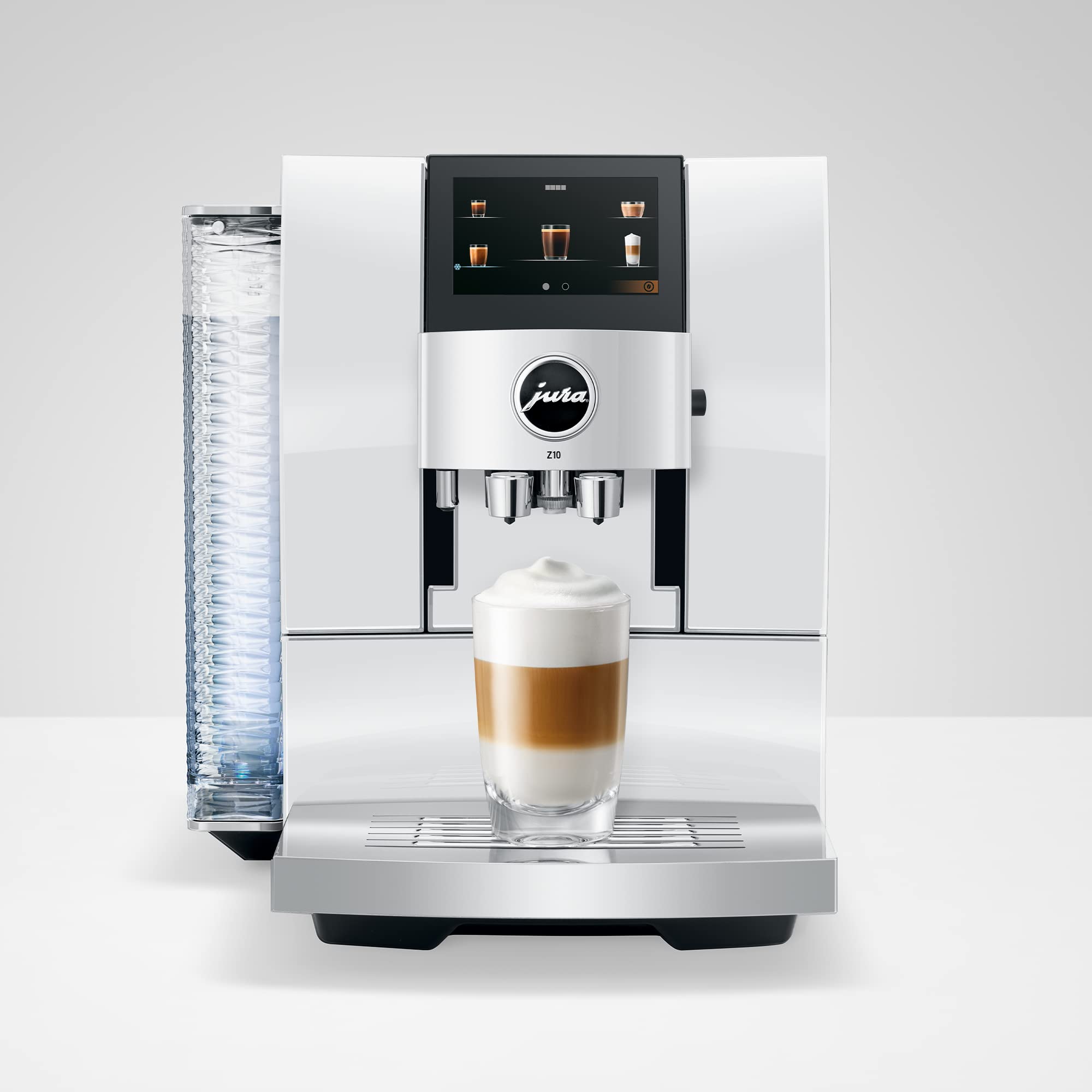 Front view of Diamond White Jura espresso machine with a creamy coffee in glass cup on stand displayed on a white background