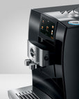 Side view of Diamond Black Jura espresso machine with a touchscreen panel displayed on a white background