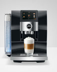 Jura coffee machine with a glass of layered coffee on a white background