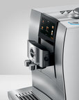 Silver coffee machine with digital display on a white background