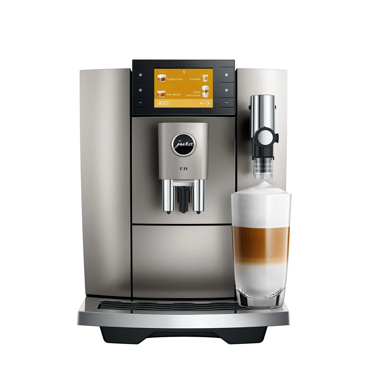 A metallic silver and black Jura coffee machine with a digital touch screen, shown next to a glass of layered latte macchiato on a white background.