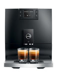 Black coffee machine with two glasses of coffee on a white background