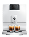 White coffee machine with two glasses of coffee on a white background