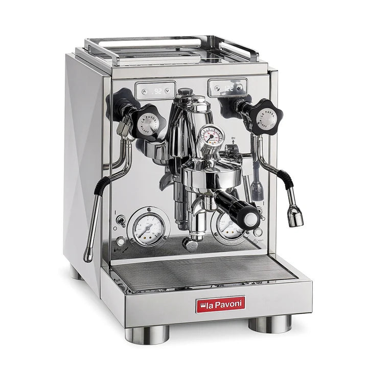 A professional stainless steel espresso machine by la Pavoni, featuring a polished chrome finish, dual pressure gauges, steam wands, and a drip tray, shown on a solid white background.