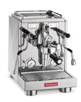 A professional espresso machine by la Pavoni, featuring a polished stainless steel body, two analog pressure gauges, a central portafilter holder, and a red brand logo plate on the front.