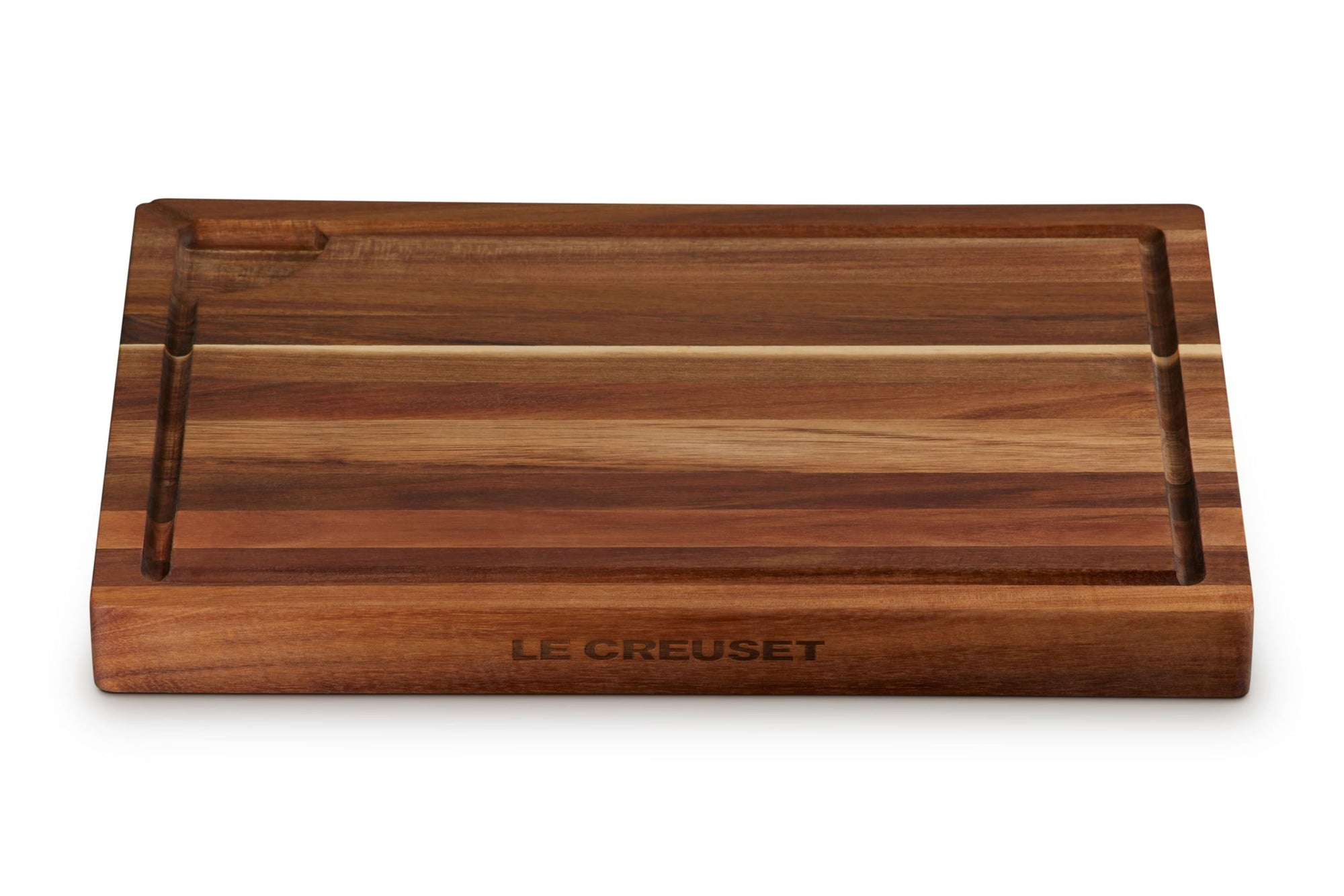 Wooden cutting board with 'Le Creuset' branding on a white background