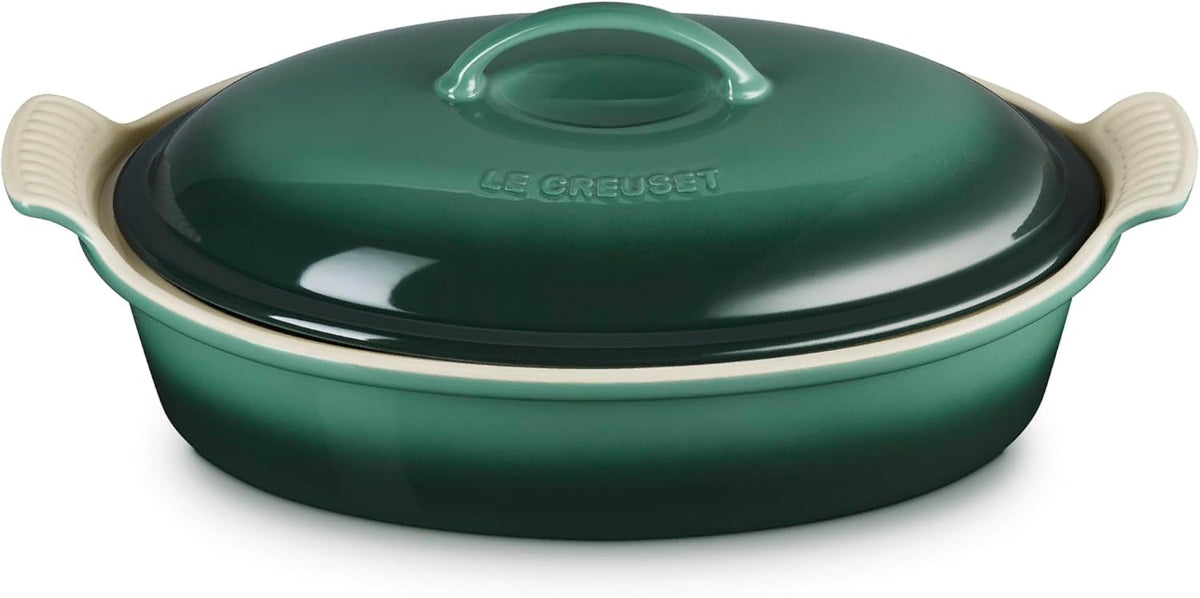 Green ceramic baking dish with lid on a white background