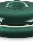 Green ceramic baking dish with lid on a white background