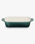 Green rectangular baking dish with cream interior on a white background
