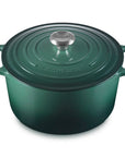 Green cast iron cookware pot with lid on a white background