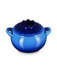 Blue ceramic pot with lid that looks like a blueberry on a white background
