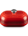 Cerise bread oven pan with lid and handles displayed on a white background