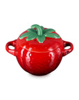 Red ceramic pot shaped like a strawberry with green stem lid on a white background